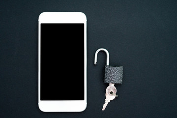 The safety of personal data, network security, confidentiality. White smartphone and padlock on a black background. View from above. Flat lay, top view, copy space.