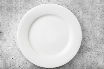 Table setting. Empty plate on a light concrete background. Top view and flat lay with copy space.