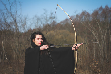 Warrior medieval woman with bow in battlefield
