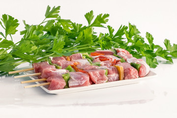 Raw meat with vegetable on the table.