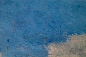 Concrete wall painted in two colors - blue and light yellow