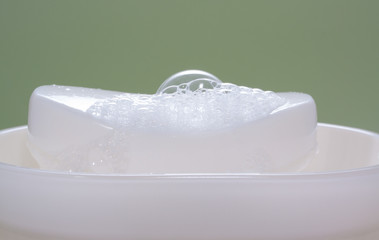 white soap bar in a soap-holder