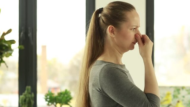 Woman reacts to stink. Bad smell. Stench. Mud.