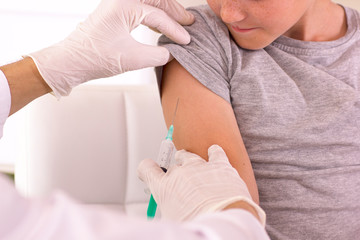 A child is given a vaccine against the virus