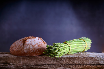 Fresh green asparagus on wooden table background. Healthy lifestyle concept.