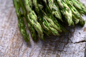Fresh green asparagus on wooden table background. Healthy lifestyle concept.
