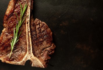  Grilled T-bone steak on a stone table. With copy space for your text.