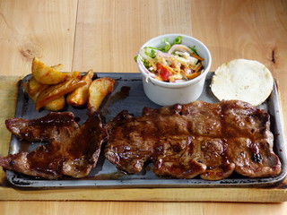 Typical Colombian dish, cow meat with arepa, french fries and salad
