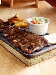 Typical Colombian dish, cow meat with arepa, french fries and salad