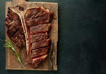  Grilled T-bone steak on a stone table. With copy space for your text.
