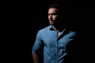 casual man standing and looking aside pensive