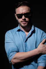 Fototapeta premium casual man standing and holding his arm serious