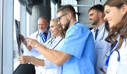 Group of doctors checking x-rays in a hospital.