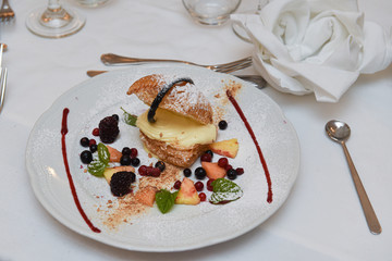 Dolce con crema e frutti di bosco servito in un ristorante