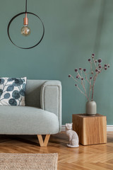 Stylish and minimalistic composition of home interior with mint sofa, pillow, wooden cube, flowers...