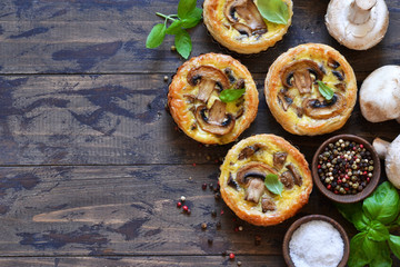 Tartlets with mushrooms and chicken on a wooden background. View from above.
