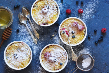 Vanilla cheesecake with berries on the kitchen table.