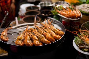 Fried king shrimps seafood by fire and BBQ Flames. Restaurant Barbecue at the night market.