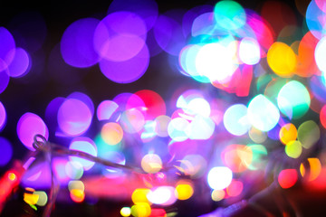 Beautiful Christmas background with garlands and bokeh. New year  multi-colored picture. Abstract photo image for design