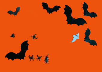 Halloween paper decorations on orange background. Halloween concept. Flat lay, top view, copy space