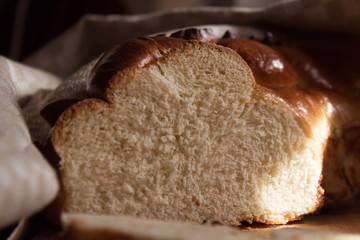 Traditional homemade bread on a wooden cutting board is on the table