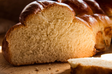 Traditional homemade bread on a wooden cutting board is on the table