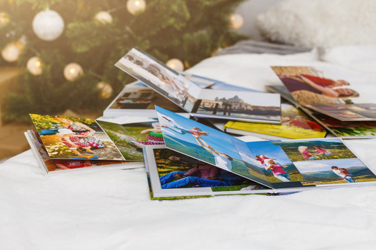 travel photo books lie near the Christmas tree