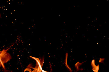 Fire sparks with flame against black background; great for overlay design