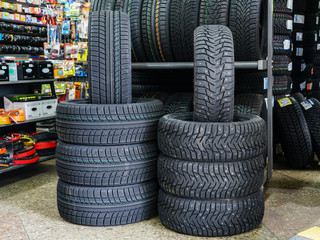 Obraz premium new winter tire sets with studs and without studs at tire shop