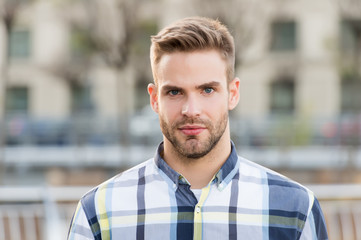 Masculine appearance. Handsome man unshaven face and stylish hair. Caucasian man urban background....
