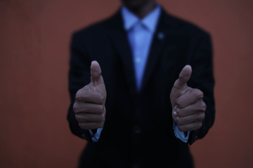 Business man shows thumb up sign gesture.