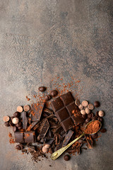 Milk and dark chocolate with cocoa powder. Top view with copy space.