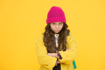 I hate school. Unhappy child on yellow background. Cute little child wear formal school uniform....
