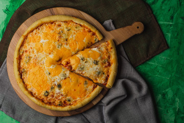 Pizza four cheese on a wooden platter. Quattro Formaggio