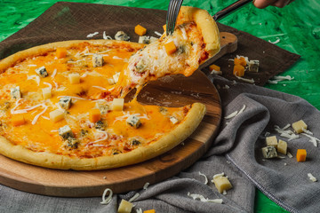 Pizza four cheese on a wooden platter. Quattro Formaggio