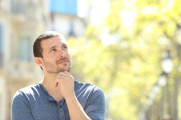 Serious adult man thinking looking at side in the street