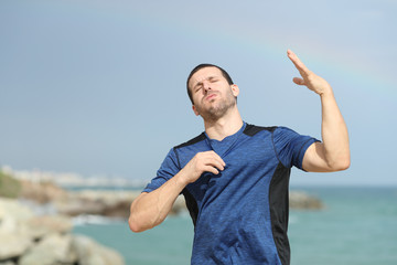 Stressed runner suffering heat stroke on the beach