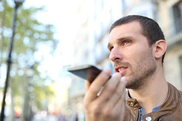 Adult man using voice recognition on phone to send a message