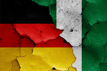 flags of Germany and Nigeria painted on cracked wall