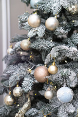 Christmas tree decorated with toys and a garland. New year background for your design. Seasonal holidays in winter