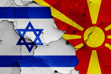 flags of Israel and North Macedonia painted on cracked wall