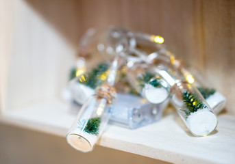 Beautiful Christmas garland in decorative jars on a bokeh background. Christmas theme design