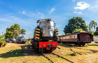 Fototapeta na wymiar Old retro steel locomotive trains and wagons standing on the rails in Livingstone, Zambia