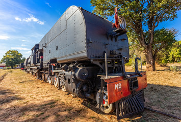 Fototapeta na wymiar Old retro steel locomotive train standing on the rails in Livingstone, Zambia