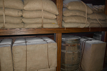 Sacks full and stacked on warehouse shelf