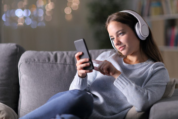 Woman listening to music using headphones and phone