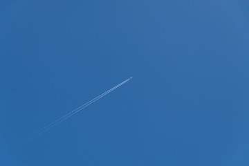 Airplane trace on clear blue sky