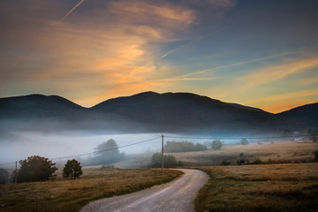 Sunrise on mountain with colorful skyline and fog Near the Drvar in Bosnia and Herzegovina