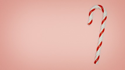 3D illustration. Red and white candy stick on a pale pink background with left copy space