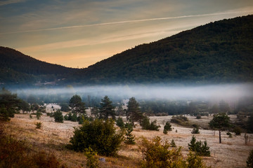 Sunrise on mountain with colorful skyline and fog Near the Drvar in Bosnia and Herzegovina